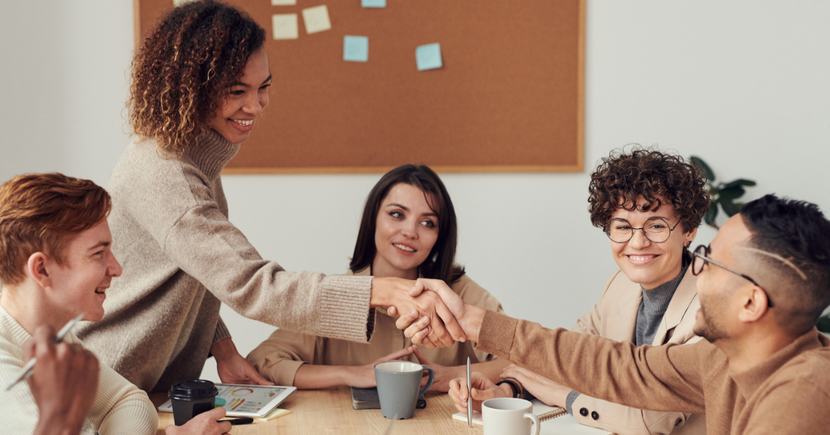 lack of communication in the workplace image featuring workers talking at a desk