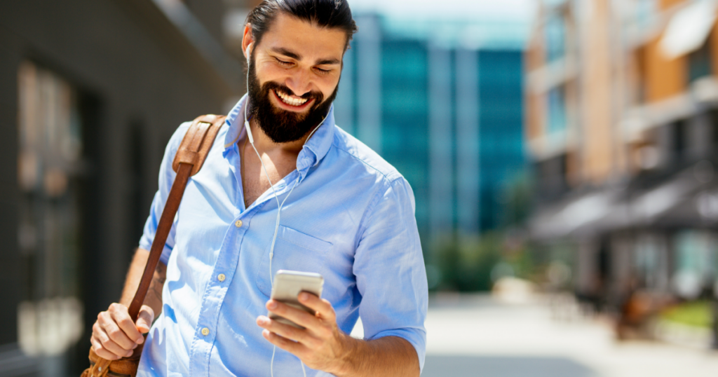 company culture examples image featuring worker smiling at smartphone