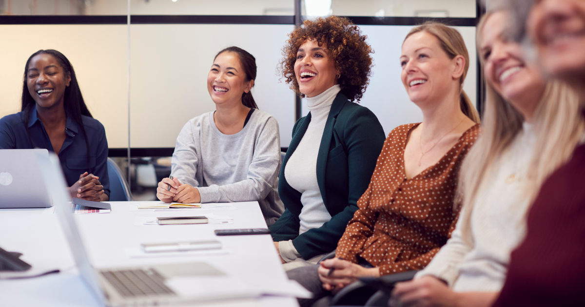 Employee retention image featuring several people smiling in an office setting