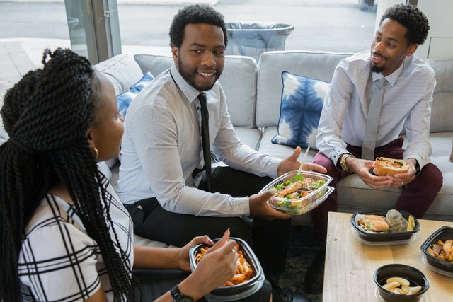 Three co-workers having lunch together