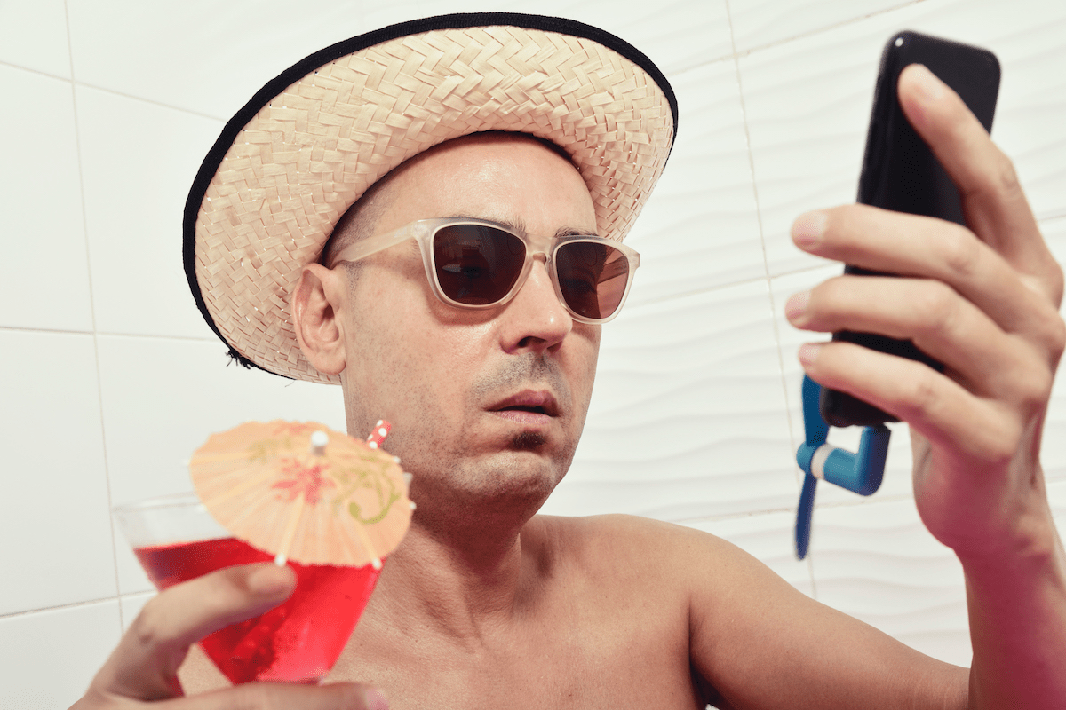 Man with drink and mobile phone