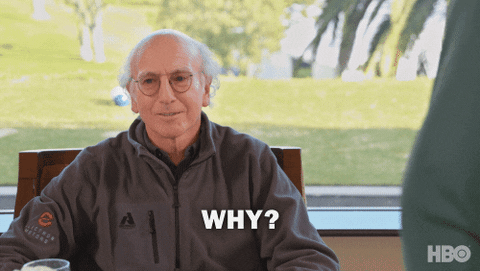 A gif of comedian Larry David. He wears round glasses and a dark grey jacket. He is outside near a golf course, seated down at a table. He shrugs and says "Why? What's the Big Deal?"