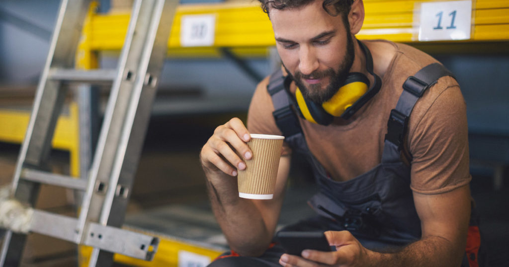 A man at work checking his employee app.